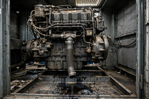 Diesel generator crankcase breather draft tube on an industrial genset engine