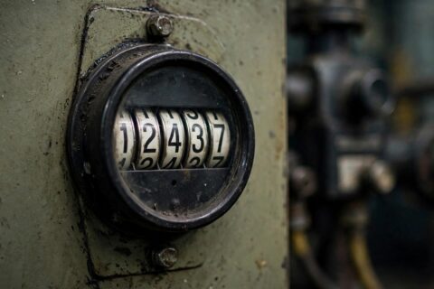 Analog engine hour meter on a diesel generator control panel in a plant room — the number buyers trust, and the number that lies most often